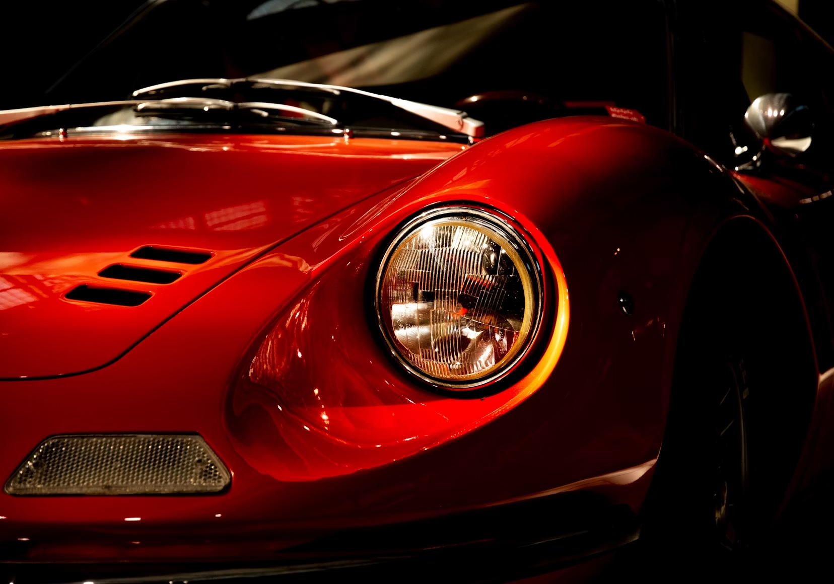 Close-up of a red classic sports car headlight